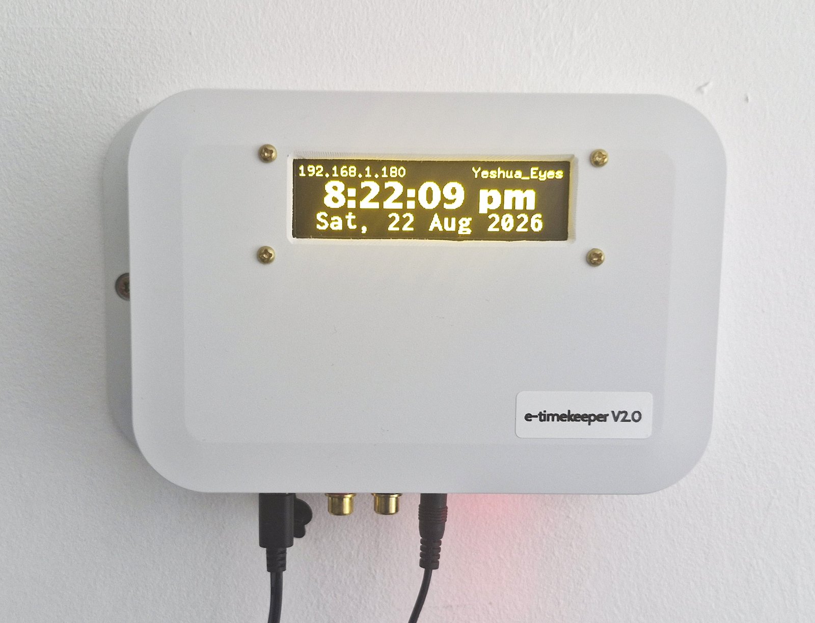 e-Timekeeper mounted on a wall beside a PA amplifier